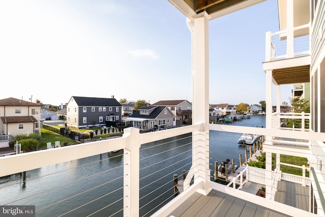 wooden terrace featuring a water view