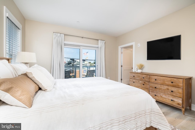 bedroom featuring access to exterior and light hardwood / wood-style floors