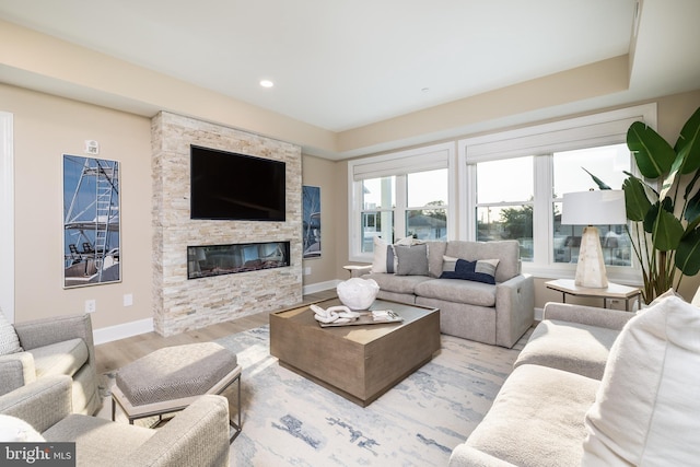 living room with a fireplace and light wood-type flooring