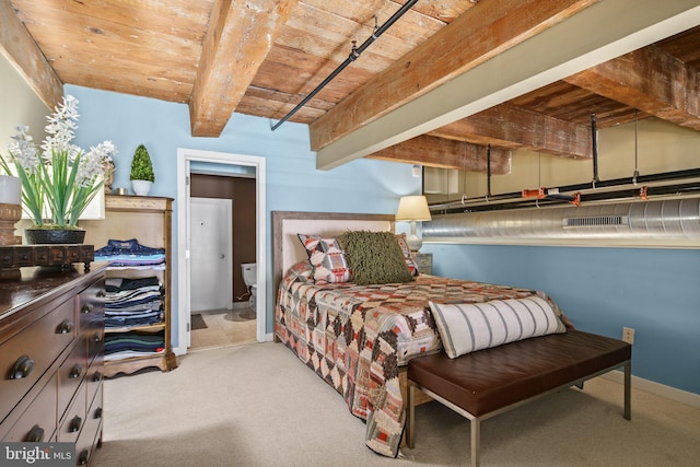 carpeted bedroom featuring beam ceiling, wood ceiling, and connected bathroom