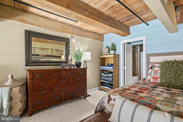 bedroom featuring beamed ceiling, light colored carpet, and wood ceiling