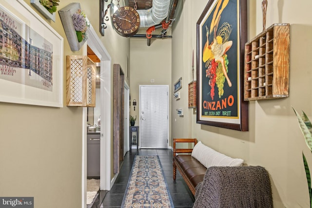 corridor featuring dark tile patterned flooring