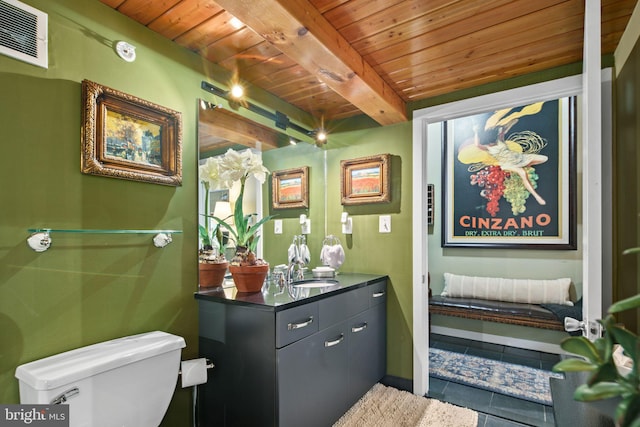 bathroom featuring beamed ceiling, toilet, wooden ceiling, and tile patterned floors