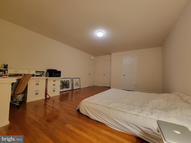 bedroom with hardwood / wood-style flooring