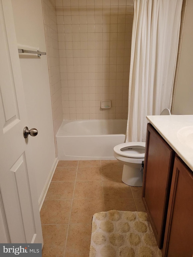 full bathroom featuring toilet, vanity, tile patterned floors, and shower / bathtub combination with curtain