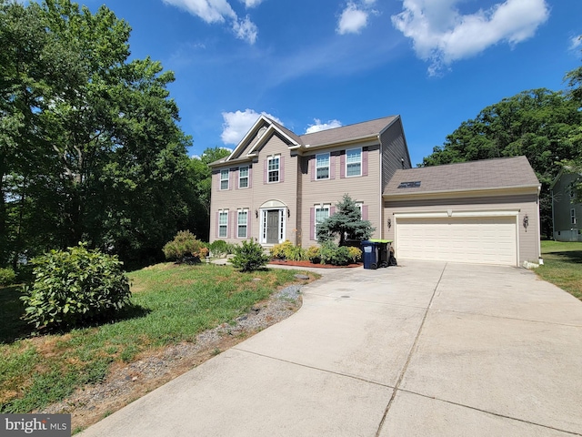 view of front of property featuring a garage and a front lawn