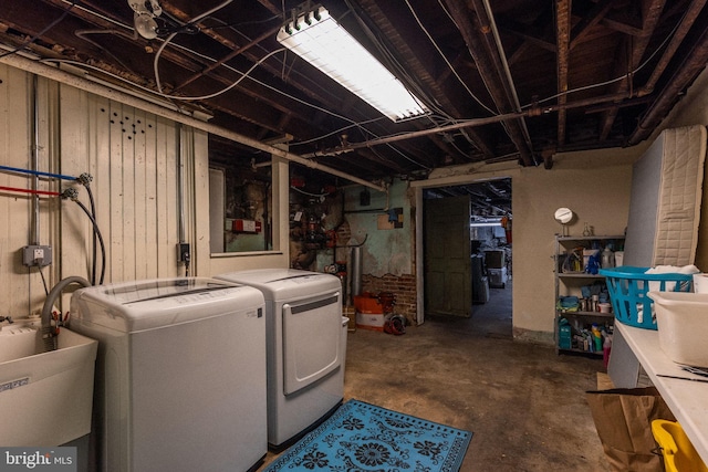 laundry room with washer and dryer and sink