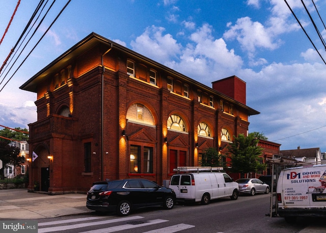 view of outdoor building at dusk