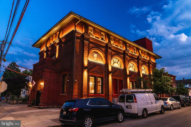 view of outdoor building at dusk