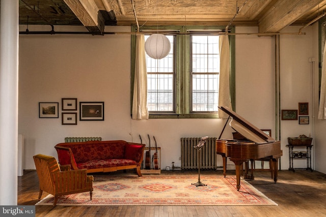 sitting room featuring radiator heating unit and hardwood / wood-style floors