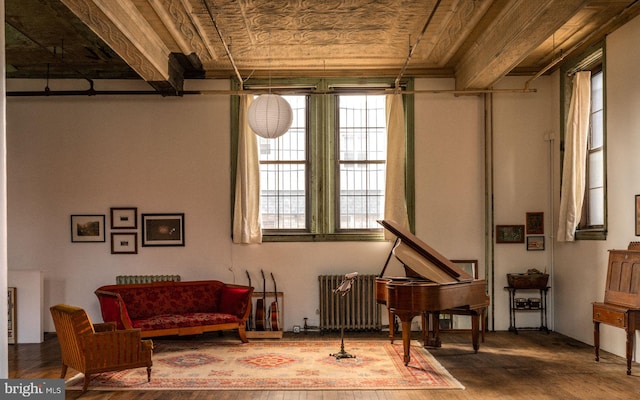 sitting room with wood ceiling, radiator heating unit, and hardwood / wood-style floors