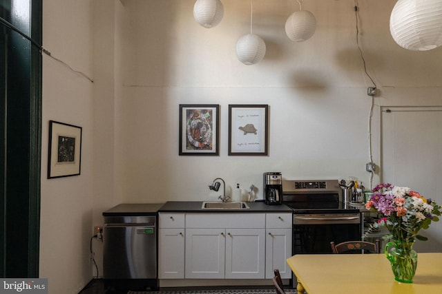 kitchen with white cabinets, sink, and appliances with stainless steel finishes