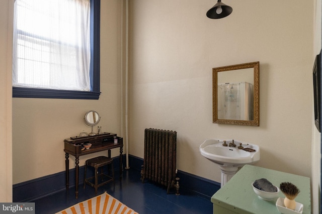 bathroom featuring radiator heating unit and sink