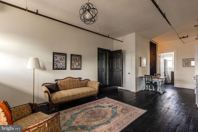 living room with dark hardwood / wood-style flooring