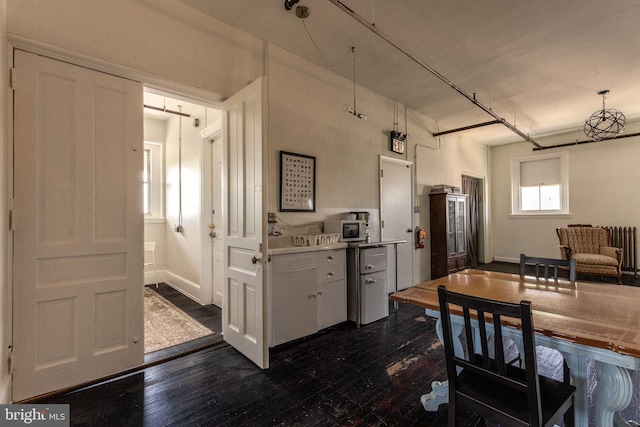 kitchen featuring white cabinetry and dark hardwood / wood-style flooring