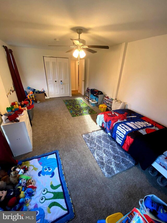 bedroom with carpet flooring, ceiling fan, and a closet