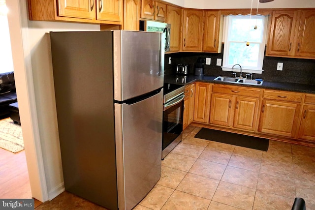 7200 Havre Turn Turn, Upper Marlboro, MD 20772 - kitchen featuring stainless steel appliances, dark countertops, decorative backsplash, brown cabinetry, and pendant lighting