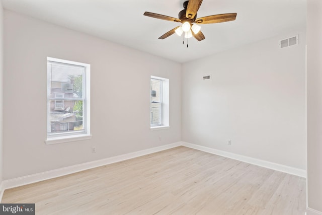 spare room featuring ceiling fan and light hardwood / wood-style flooring