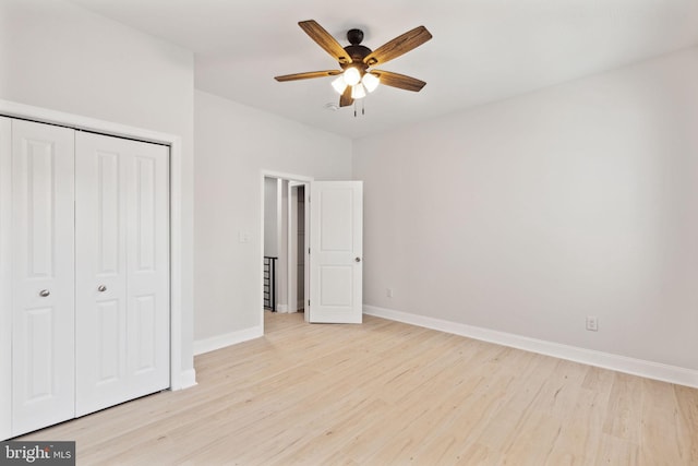 unfurnished bedroom featuring a closet, light hardwood / wood-style flooring, and ceiling fan