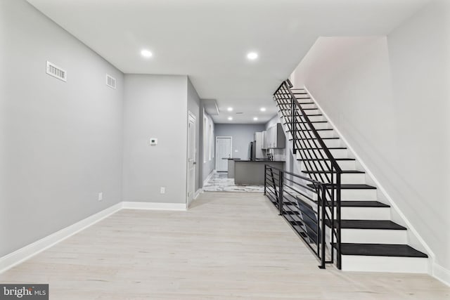 stairs featuring hardwood / wood-style flooring