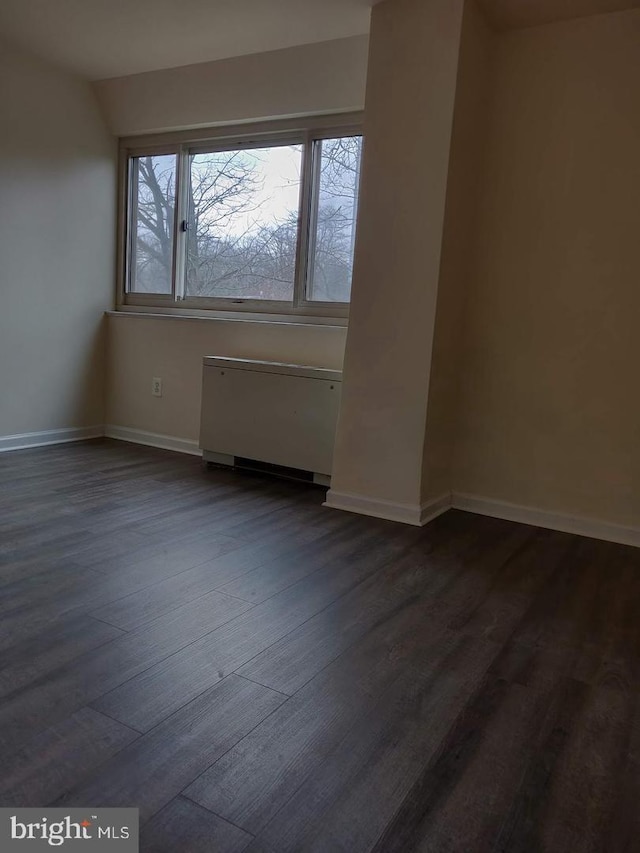 spare room featuring dark hardwood / wood-style flooring