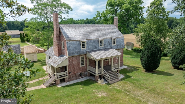 rear view of property with covered porch