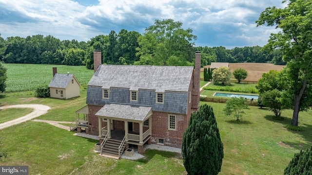 rear view of property with an outbuilding