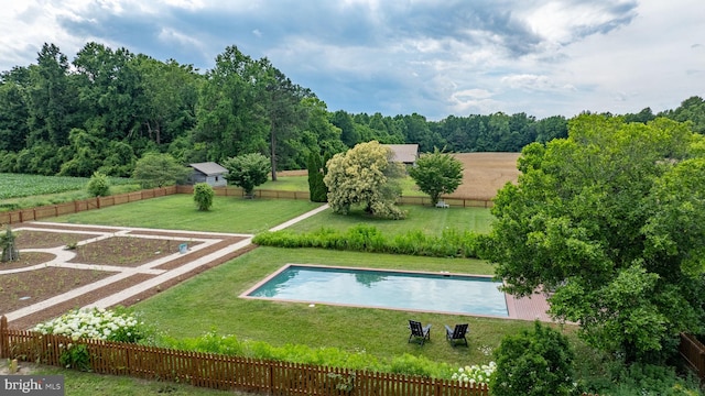 view of pool featuring a yard