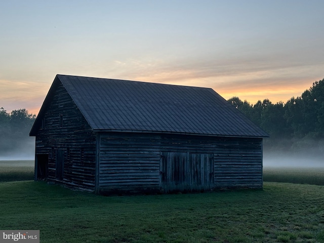 outdoor structure at dusk with a yard