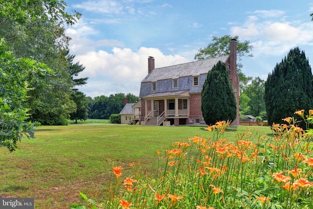 rear view of house with a lawn