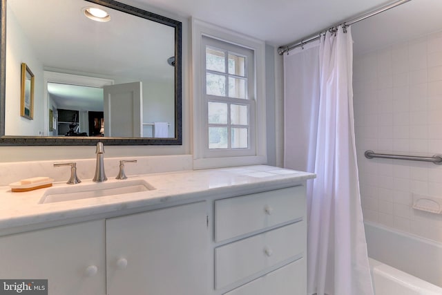 bathroom featuring vanity and shower / tub combo with curtain