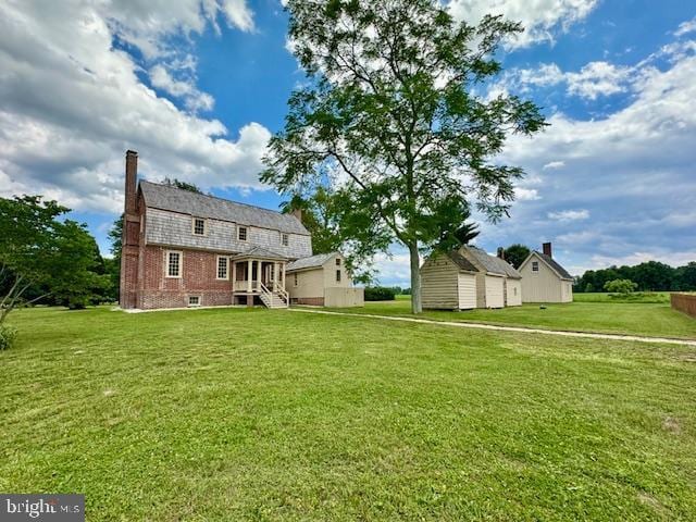 rear view of house featuring a lawn