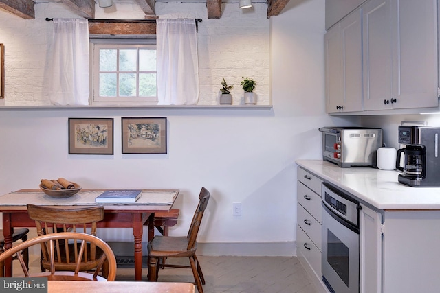 kitchen with stainless steel oven and white cabinets