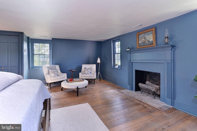 bedroom featuring multiple windows and hardwood / wood-style floors