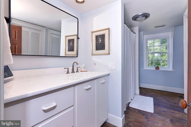 bathroom with hardwood / wood-style floors and vanity