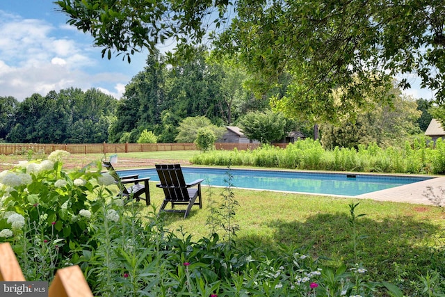 view of pool featuring a yard