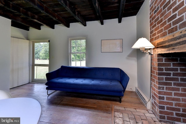 unfurnished room with hardwood / wood-style floors, beam ceiling, and a baseboard radiator