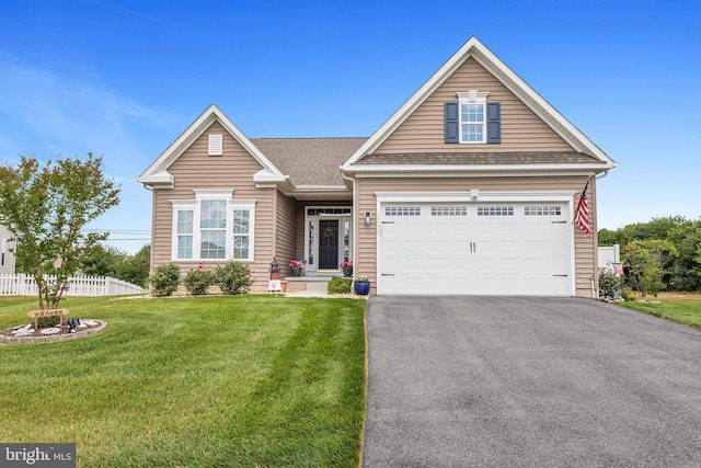 view of front of property featuring aphalt driveway, fence, a shingled roof, and a front lawn