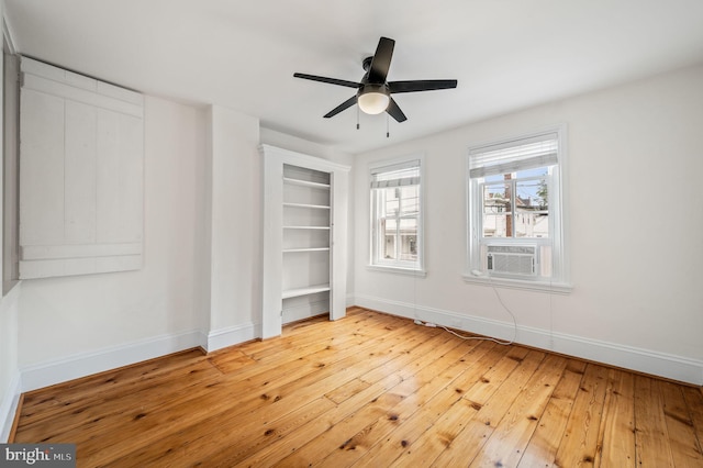 unfurnished bedroom featuring ceiling fan, cooling unit, and hardwood / wood-style flooring