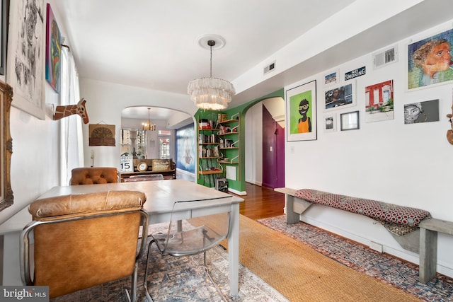 interior space with hardwood / wood-style floors and a notable chandelier