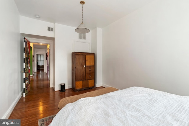 bedroom with dark wood-type flooring