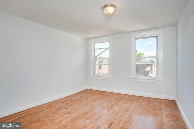 spare room with light wood-type flooring