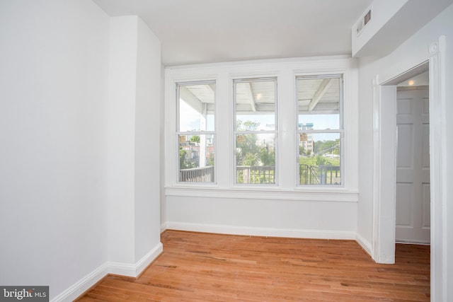 unfurnished room with a wealth of natural light and light wood-type flooring