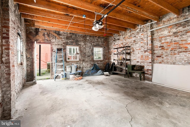 misc room with beam ceiling, concrete floors, and wooden ceiling