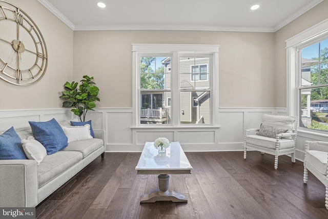 living area with crown molding and dark hardwood / wood-style floors