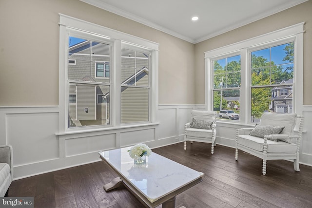 sitting room with ornamental molding and dark hardwood / wood-style floors