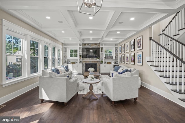 living room with dark hardwood / wood-style flooring, coffered ceiling, a wealth of natural light, and a fireplace