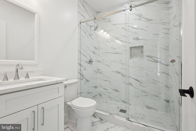 bathroom featuring vanity, toilet, and an enclosed shower