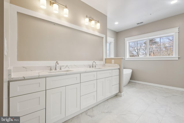 bathroom with a tub to relax in and vanity