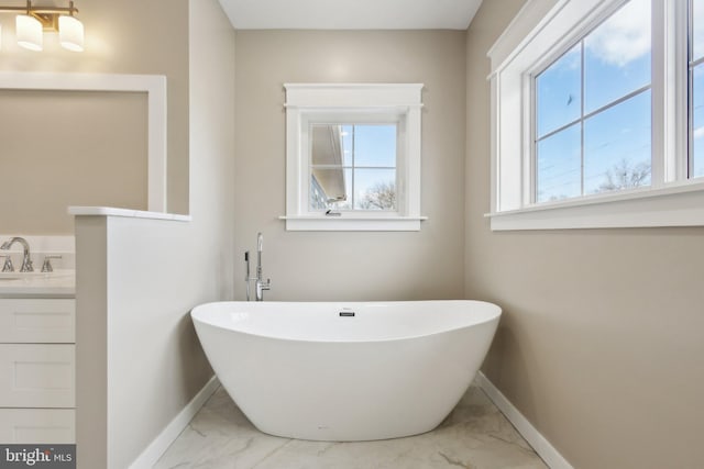 bathroom featuring vanity and a tub